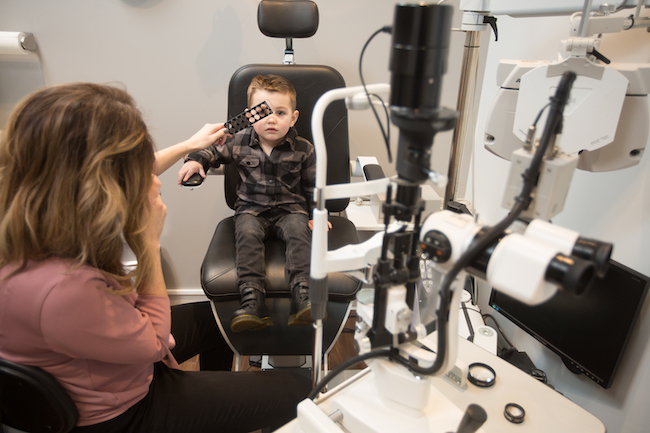Photo of Dr. Walz giving a pediatric eye exam